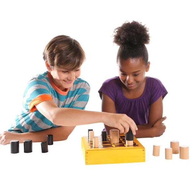 Elementary aged boy and girl smiling and playing a board game.