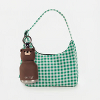 Sure! Here’s a rewritten sentence using the given product data: A green and white checkered handbag with a brown bear-shaped keychain and an Asobu Bottle Mini Brown Bear Bestie Bottle Vacuum Flask by AdnArt Inc attached to the strap, set against a plain white background.