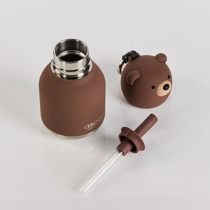 The Mini Brown Bear Bestie Bottle Vacuum Flask by Asobu Bottle/AdnArt Inc features a cute brown insulated design with a metal rim, a bear-shaped lid, and a convenient straw attachment. Perfect for little ones who love adorable animal-themed designs, this charming vacuum flask is shown placed on a white surface.