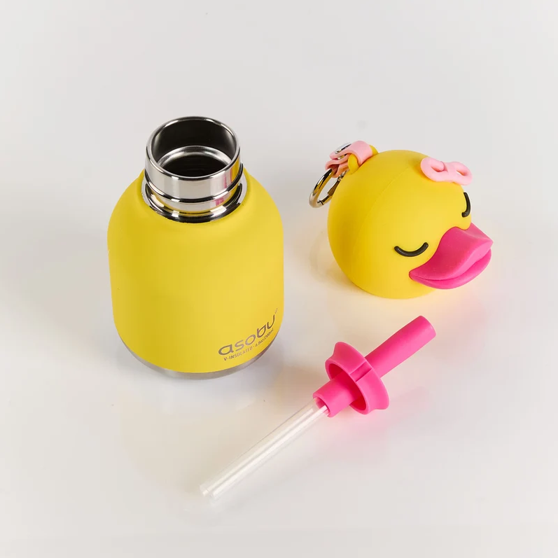 The Asobu Bottle/AdnArt Inc Mini Duck Best Bottle Vacuum Flask is a yellow insulated kids’ flask with a stainless steel opening, featuring an adorable animal design. Its duck-shaped cap comes complete with a pink bow and beak, and it includes a matching pink straw attachment placed beside the flask—all displayed on a clean white background. This vacuum-insulated stainless steel flask keeps your child’s drinks at the perfect temperature.