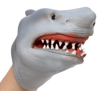 A person is wearing the Schylling Toys Shark Hand Puppet in gray, featuring an open mouth with sharp white teeth and pink gums—perfect for imaginative play and entertaining puppet shows.