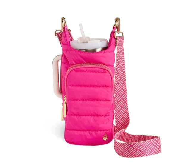 Introducing the Wander Full Brand’s HydroBag Handle Pink: a vibrant pink insulated water bottle holder, featuring a zippered front pocket and an eye-catching pink-and-white adjustable shoulder strap. Designed to hold your cup with a straw, this stylish carrier includes a sturdy HydroBag Handle Pink for added comfort—combining practicality with standout style.