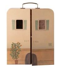 The Maileg SuitCasa, Little Sister and Brother Mouse is a miniature suitcase by Maileg, designed to resemble a charming house facade. It features two painted windows with green shutters, a potted plant, and the words “Suit Casa” on the front. Slightly open in the center, this delightful piece is perfect for pretend play or as a unique addition to your Maileg accessories collection.