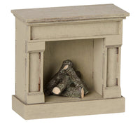 An off-white, wooden Maileg Fireplace designed for mice, featuring stacked logs inside and perfect for dollhouse or miniature displays.