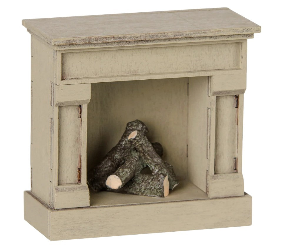 An off-white, wooden Maileg Fireplace designed for mice, featuring stacked logs inside and perfect for dollhouse or miniature displays.