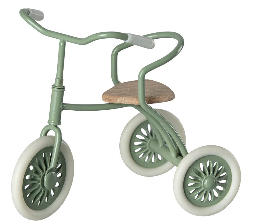 The Maileg Tricycle Garage (Green) by Maileg is a small green toy tricycle with white wheels, a wooden seat, and simple handlebars—ideal for storing Maileg mouse accessories—shown against a white background.