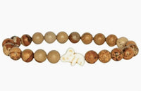 The Lounge - Dune Kaola bracelet by fahlo features round, brown-toned beads with a white koala accent, beautifully arranged in a circle on a plain white background—ideal for supporting wildlife conservation.