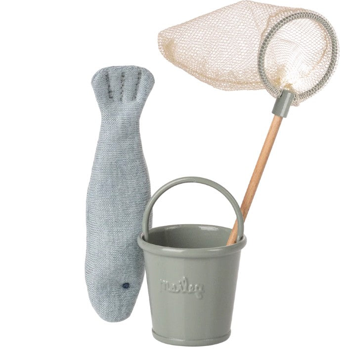 The Maileg Fishing Set, Mouse by Maileg includes a grey fabric fish, a small green Maileg bucket, and a toy fishing net with wooden handle—perfect miniature fishing accessories for your Maileg Mouse.