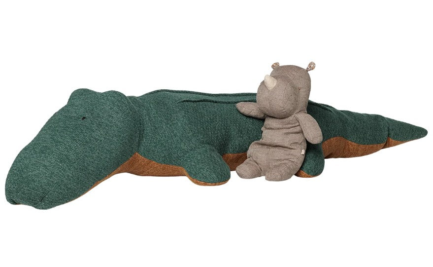 The Maileg Safari friends, Crocodile, Giant, with its cuddly design from Maileg, lies on its stomach as a small gray rhinoceros plush toy rests comfortably on its back.