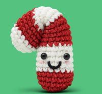 Peppi the Candy Cane Crochet Kit by The Woobles features a red-and-white striped plushie with a cute face—ideal for holiday crafts or as a beginner crochet kit.
