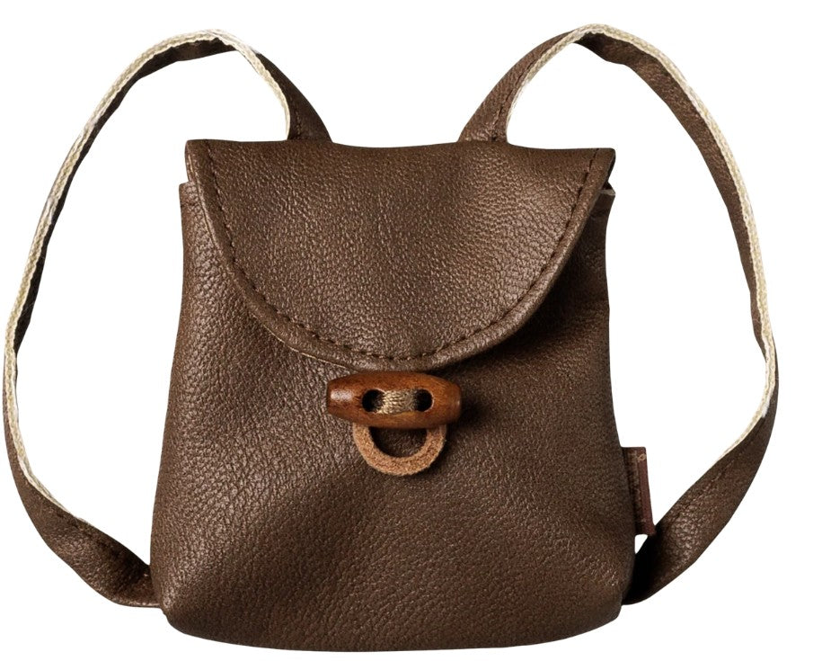 The Maileg Backpack, Medium mouse by Maileg is a small brown leather miniature backpack featuring a flap closure, looped strap, and a simple buckle detail on the front—perfect for imaginative play with your Medium Mouse companion. Displayed against a white background.