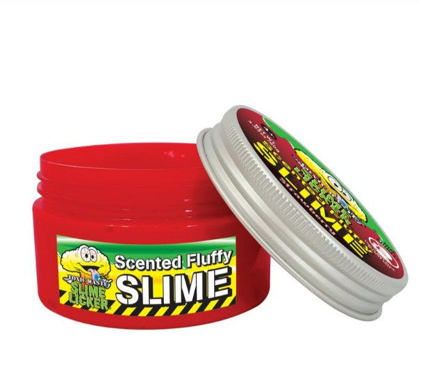A red plastic container labeled "Toxic Waste Slime Licker Scented Fluffy Slime" by License 2 Play, with a partially removed silver lid revealing the scented fluffy slime inside. Designed for sensory play, the label showcases a cartoon slime character and vibrant, colorful graphics reminiscent of classic Toxic Waste Slime Licker branding.