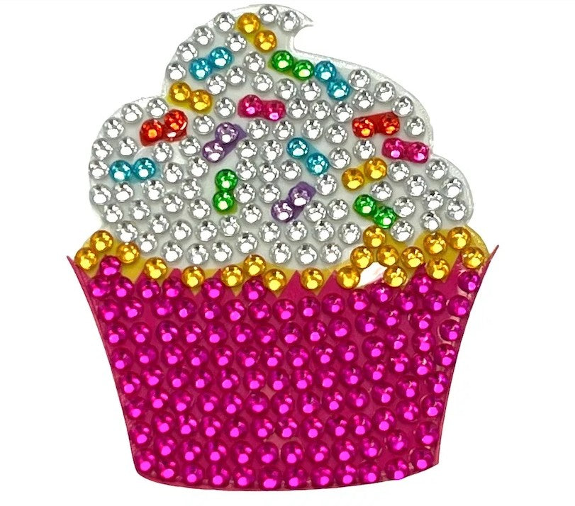 Introducing the StickerBean Vanilla Cupcake by StickerBean: a charming, cupcake-themed sticker crafted with vibrant rhinestones. It features shimmering silver frosting, rainbow sprinkles, and a vivid pink wrapper—an irresistibly sweet addition that brings sparkling fun to any sticker collection.