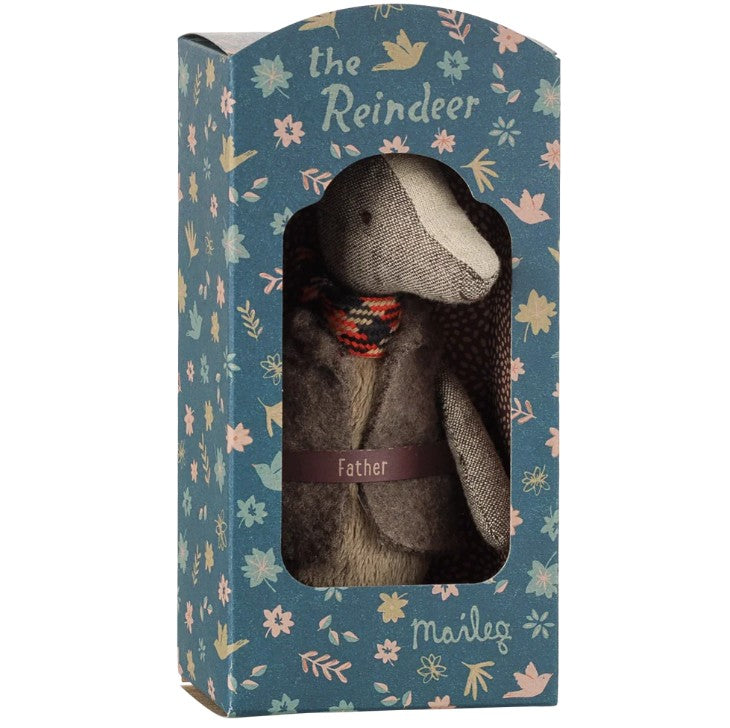 A fabric Maileg Reindeer, Father doll wearing a scarf is showcased inside a blue, flower-adorned box with a clear window. Ideal for imaginative play, the box is labeled “Father” and highlights the charming Maileg branding along with “the Reindeer.”.