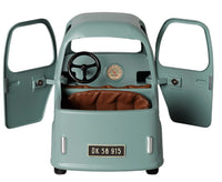 A small, vintage-style Maileg Truck, Mouse by Maileg in light blue features both doors open to reveal a brown seat, black steering wheel, and visible speedometer inside. The license plate reads DK 56 915—perfectly mouse-sized for miniature adventures.