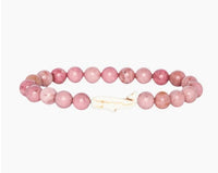 The fahlo Wayfare - Pink Sands Whale bracelet features round pink beads and a white whale-shaped bead at the center, shown on a plain white background.