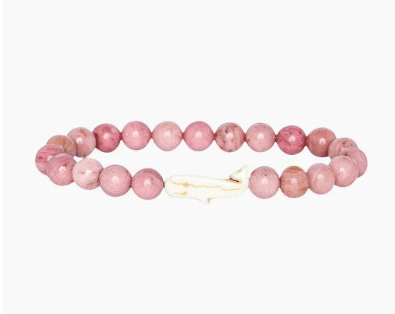 The fahlo Wayfare - Pink Sands Whale bracelet features round pink beads and a white whale-shaped bead at the center, shown on a plain white background.