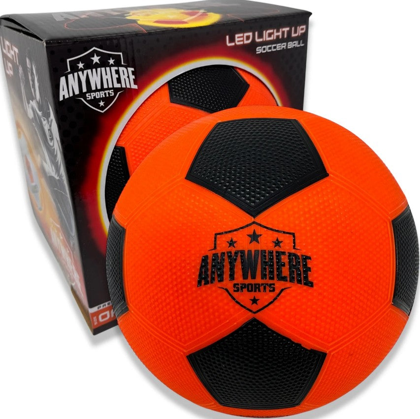 A Pro Glow Light-Up Soccer Ball No. 5 from Thin Air Brands, LLC is shown next to its packaging box, both featuring matching orange and black designs with brand graphics. This Glow Soccer Ball includes bright LED lights, making it ideal for nighttime play.