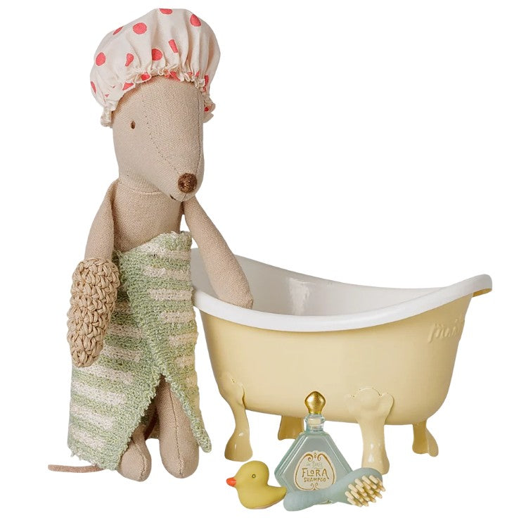 The Maileg Bathtub set, Mouse - Yellow features a stuffed mouse wearing a shower cap and holding a striped towel next to a charming miniature bathtub, complete with a toy rubber duck, brush, and a bottle labeled Flora Soap—an ideal accessory for any Maileg mouse home.