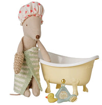The Maileg Bathtub set, Mouse - Yellow features a stuffed mouse wearing a shower cap and holding a striped towel next to a charming miniature bathtub, complete with a toy rubber duck, brush, and a bottle labeled Flora Soap—an ideal accessory for any Maileg mouse home.
