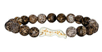 Sprint - Kalahari Cheetah by fahlo is a beaded bracelet with round, mottled brown and white stones and a carved cheetah-shaped bead, inspired by wildlife conservation and cheetah tracking.