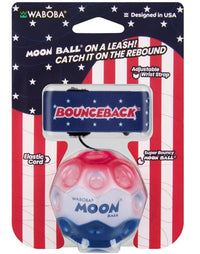 The Waboba USA / Stars & Stripes Bounceback features a red, white, and blue design inspired by the American flag, attached to an elastic cord and an adjustable wrist strap labeled BOUNCEBACK. Perfect for outdoor active play, this ball’s package highlights its extreme bounciness—making it a fun twist on the beloved Moon Ball.