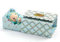 The DJECO Tinyly Blue Tinyroom by DJECO features a pastel blue patterned gift box, labeled "Blue & Bubble," which opens to reveal a charming doll and a small matching teddy bear—each with blue curly hair and reminiscent of the adorable Tinyly figures. The partially open box beautifully displays these delightful items inside.
