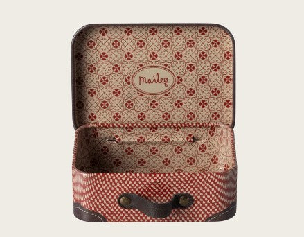 The Maileg Suitcase, Micro - Red by Maileg features a small open design with a red and cream geometric pattern, brown corners, and “Maileg” printed on the inside lid. Perfect for miniature adventures and pretend play, this empty suitcase includes a secure clasp closure.
