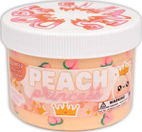 The Dope Slime Peach Princess by Dope Slime is a peach-colored, peach pie-scented premium slime designed for stress relief and sensory play. It comes in a plastic container adorned with peach and crown illustrations, along with a warning label regarding small parts.