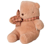A plush Mini Maileg Teddy bear in vintage rose, wearing a plaid bow around its neck, sits upright facing slightly left against a white background—a charming addition from Maileg.