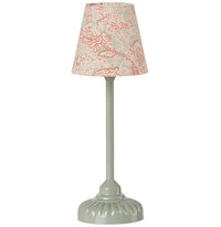 The Maileg Vintage Floor Lamp, Mouse - Mint by Maileg features a light green sculpted base and a fabric lampshade with a cream background and red floral pattern—perfect as a charming decorative accent.