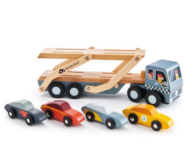 The Tenderleaf Car Transporter features a blue cab, wooden ramps, four colorful toy cars, and illustrated drivers with checkered details—perfect for inspiring imaginative vehicle play.