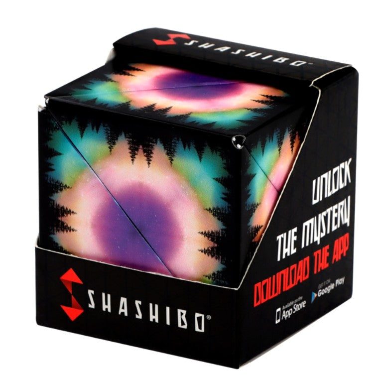The Fun in Motion Shashibo - Moon is a magnetic puzzle cube decorated with vibrant, circular aurora patterns and black tree silhouettes, featuring celestial-inspired artwork. It comes packaged in a sleek black box that says, “Unlock the Mystery. Download the App.”.