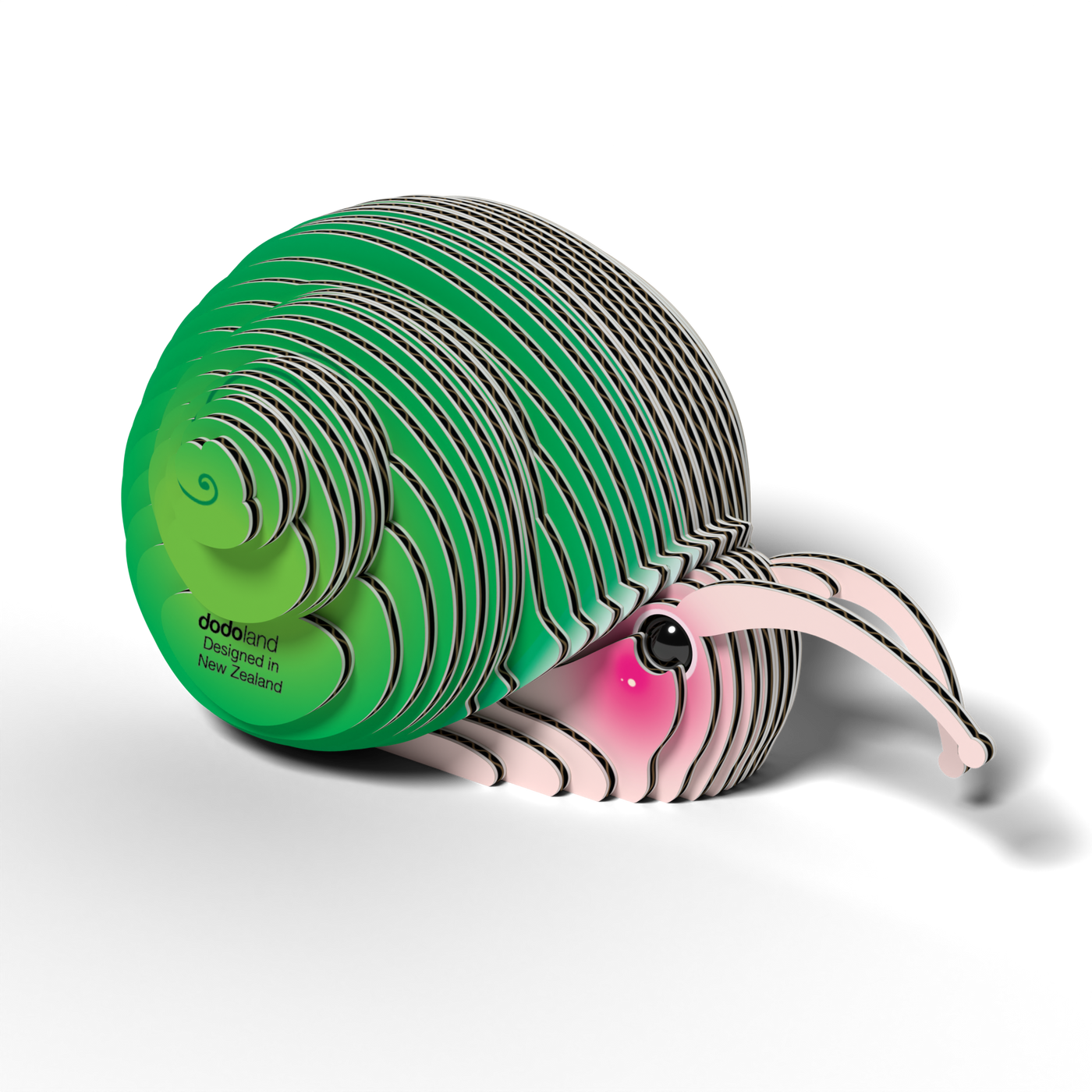 The Eugy EUGY Snail 3D Puzzle is an eco-friendly, layered paper sculpture of a snail with a green spiral shell and pink body, cartoon eye, and "dodoland" text on the shell. Designed in New Zealand by Eugy.