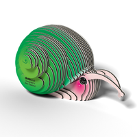 The Eugy EUGY Snail 3D Puzzle is an eco-friendly, layered paper sculpture of a snail with a green spiral shell and pink body, cartoon eye, and "dodoland" text on the shell. Designed in New Zealand by Eugy.