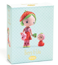 The DJECO Tinyly Berry & Lila toy box by DJECO features two collectible figures from the Tinyly collection: Berry, a larger figurine with a strawberry hat, pink dress, and tea-time accessories like a teapot and cup, and Lila, a smaller figure wearing a strawberry hood.