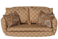 A charming Maileg Sofa Bed, Mouse, Large – Ocher, from Maileg, features a cozy ocher tone with a repeating floral pattern and includes two matching floral pillows—evoking the iconic Maileg mouse sofa bed style and beautifully displayed against a white background.