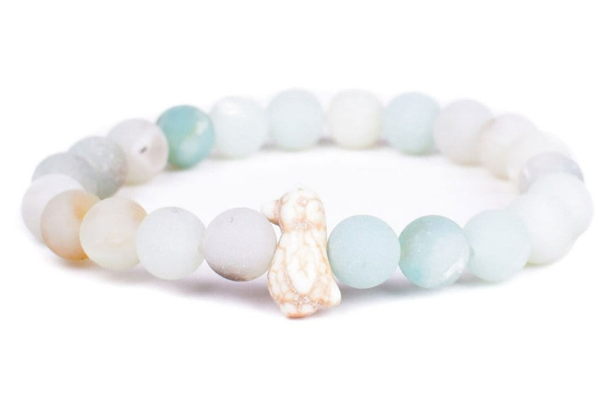 The Passage - Sky Stone Penguin bracelet by fahlo features frosted pastel beads and a cute penguin charm, inspired by wildlife conservation and reminding us of the importance of protecting species through efforts like penguin tracking.
