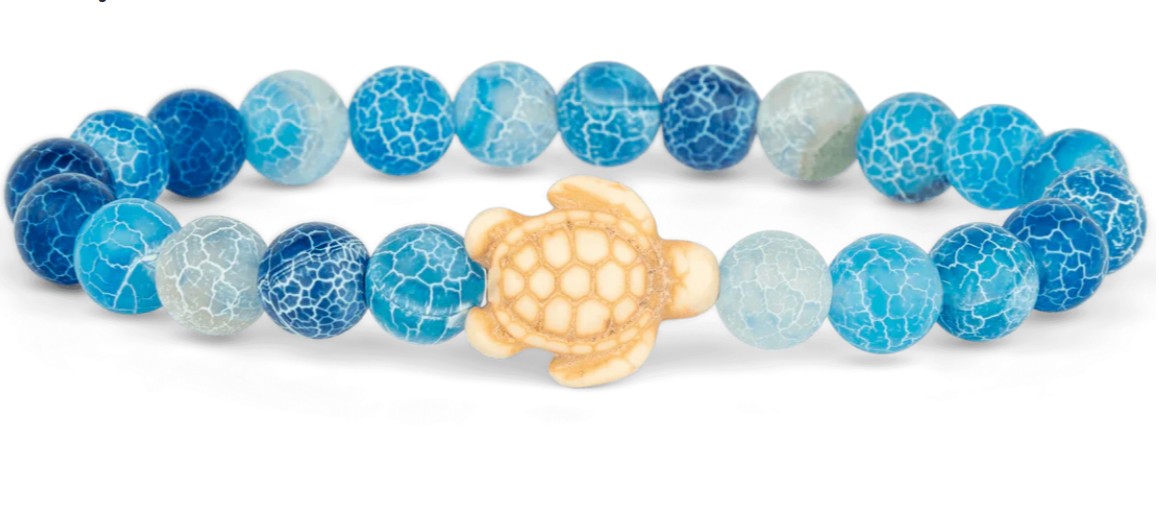 The fahlo Journey - Aqua Blue Sea Turtle bracelet features blue and white crackle round beads with a beige turtle centerpiece, inspired by ocean conservation.
