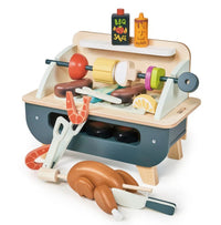 The Tenderleaf Barbeque Play Set features a mini wooden grill and play food like kebabs, shrimp, chicken, lemon slice, sausages, plus BBQ sauce and honey mustard bottles—perfect for tabletop fun.