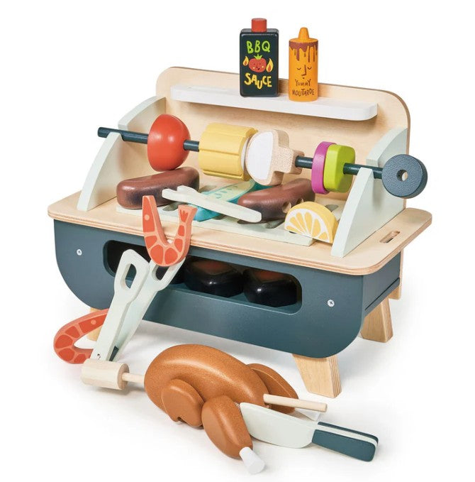 The Tenderleaf Barbeque Play Set features a mini wooden grill and play food like kebabs, shrimp, chicken, lemon slice, sausages, plus BBQ sauce and honey mustard bottles—perfect for tabletop fun.