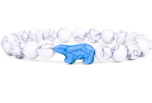 The fahlo Venture - Arctic White Polar Bear bracelet features round white marbled beads with a central blue bear-shaped bead, combining style and wildlife conservation inspiration.