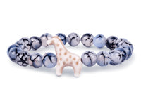 The fahlo Trek - Keystone Giraffe bracelet features round blue and white marbled beads with a ceramic giraffe charm, offering a playful accessory inspired by giraffe conservation.