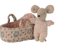 The Maileg Baby Mouse In Carry Cot - Rose features a small mouse in a pink knitted outfit with a floral carry cot, pink interior, and two handles—perfect for nurturing play.