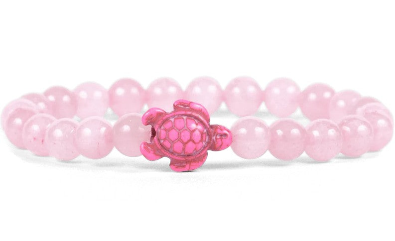 The fahlo Journey - Coral Reef Pink Sea Turtle bracelet showcases round, light pink beads and a shiny pink turtle charm—ideal for those passionate about marine conservation.