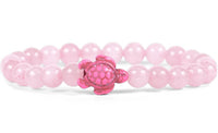 The fahlo Journey - Coral Reef Pink Sea Turtle bracelet showcases round, light pink beads and a shiny pink turtle charm—ideal for those passionate about marine conservation.