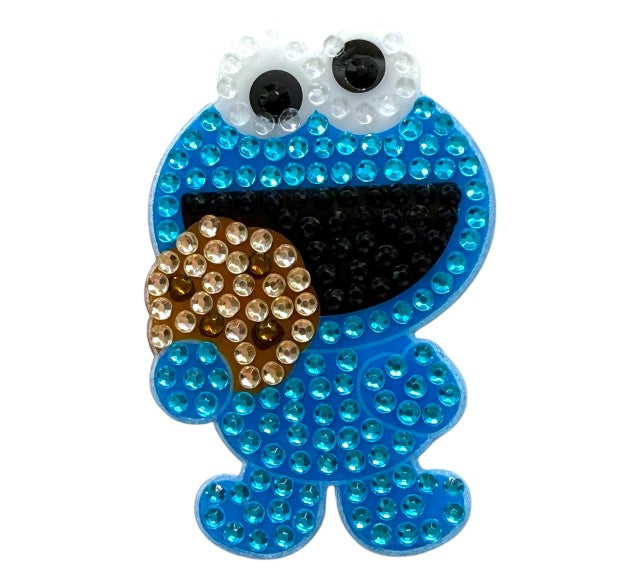 StickerBean Cookie Monster by StickerBean is a sparkling character sticker made with blue, black, white, and brown rhinestones that features Cookie Monster holding a cookie—perfect for any Sesame Street fan.