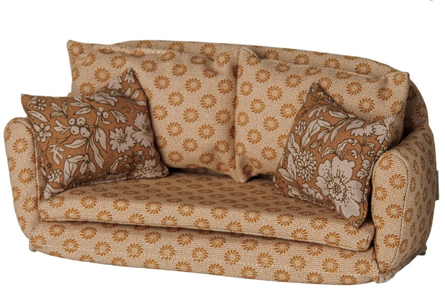 A large, ocher Maileg mouse sofa bed with a floral and geometric pattern, featuring two matching square pillows with white and brown floral designs.