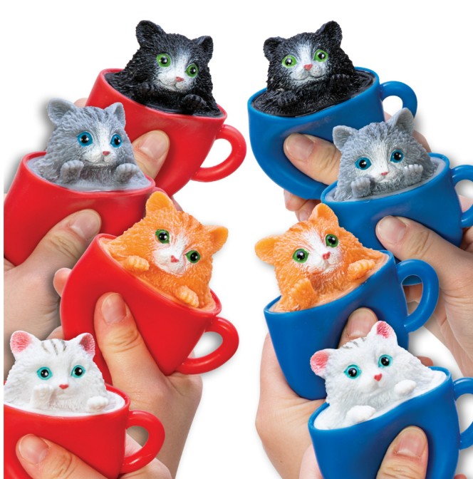 Eight colorful Pop-a-Chino Kittens toy teacups from Schylling Toys, held by hands, each feature an adorable, lifelike kitten figurine in a variety of colors such as black, gray, orange, and white. Designed as a charming cat fidget and sensory toy, these kittens seem to peek out playfully—providing both delightful fun and stress relief for all ages.