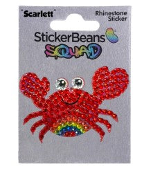 A sparkly red crab sticker named StickerBean Scarlette, featuring large eyes, a cheerful smile, and a rainbow detail on its body, is displayed on a card labeled with the StickerBean brand. This playful character design makes it the perfect decorative sticker for adding fun to your collection.